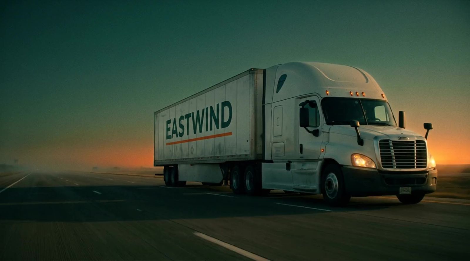 Eastwind semi truck driving on the interstate at dawn